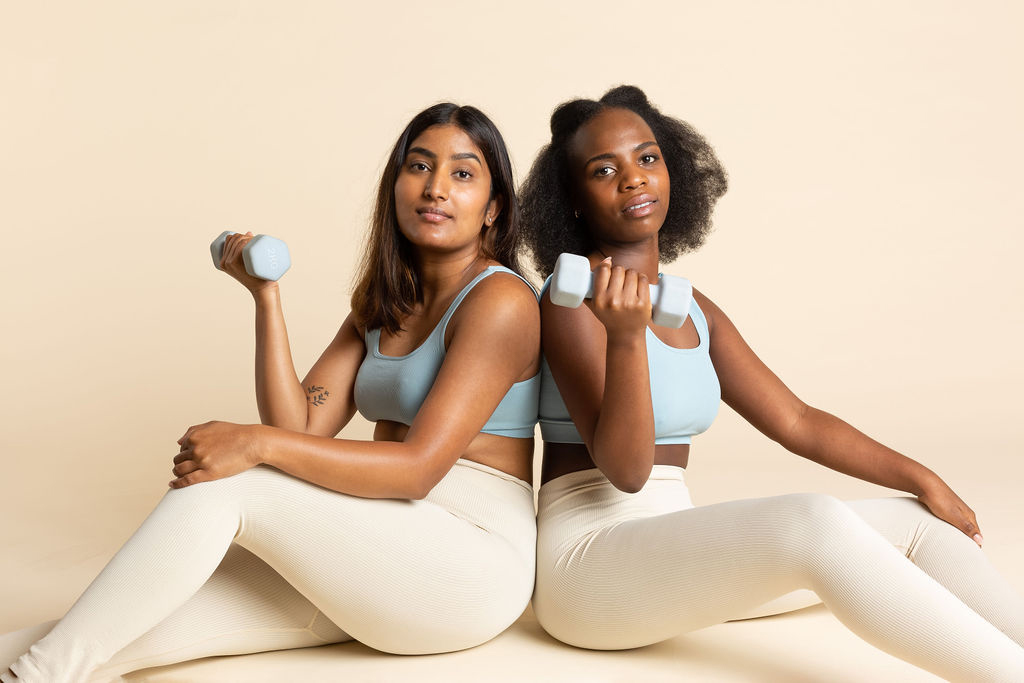 Two women holding dumbbells